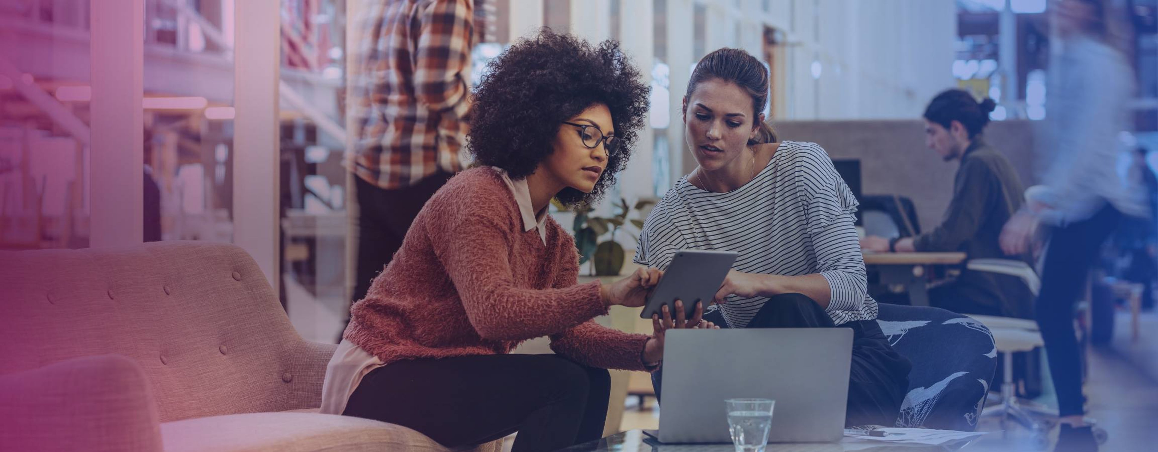 Two women working on a laptop